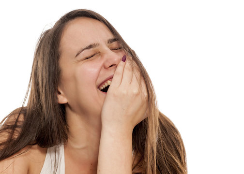 young woman laughs on white background