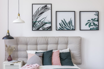 Floral posters in bright bedroom