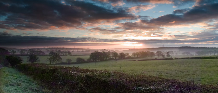 Sunrise on misty morning in countryside near Hambledon Hampshire UK
