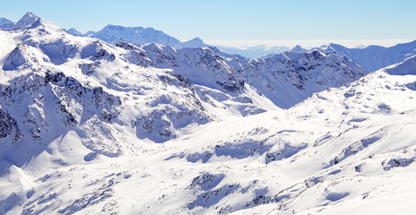 Fototapeta premium High mountains under snow in the winter. Slope on the skiing resort, European Alps