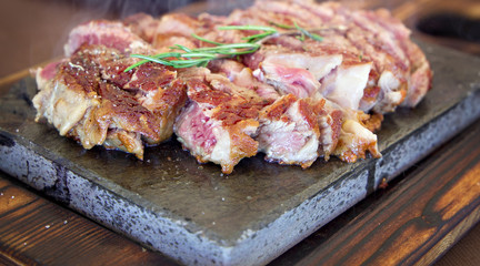 Tasty hot steak served on a hot stone.