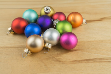 Christmas baubles on wooden background, copy space
