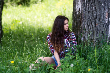 Fototapeta premium Beautiful girl is stylish and fashionably dressed in the park