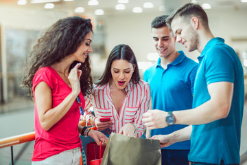 Group Of Young Friends Shopping In Mall Together
