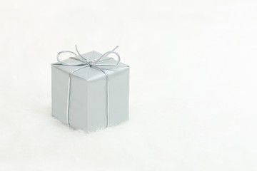 Silver gift box on a white background, copy space. Holiday concept