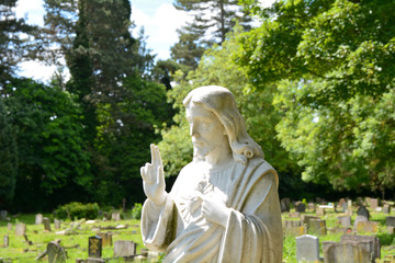 Statue of Jesus Christ on grave in cemetery