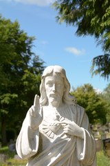 Statue of Jesus Christ on grave in cemetery
