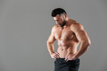 Portrait of a muscular strong shirtless male bodybuilder