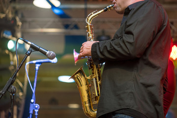Saxophonist playing a saxophone.