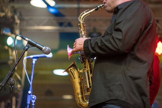 Saxophonist playing a saxophone.