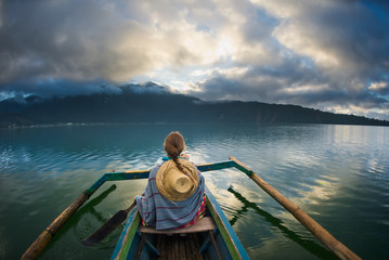 girl traveler boating on a lake