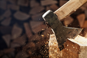 Chopping wood with axe - closeup on flying wooden chips - copy space