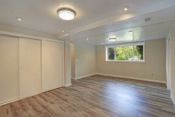 Bright beige large empty room with hardwood floor