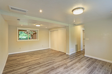 Bright beige large empty room with hardwood floor