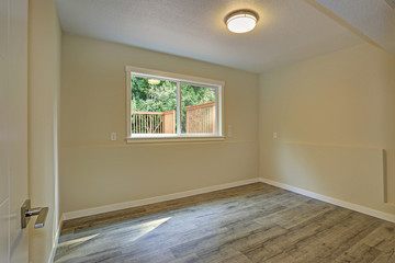 Bright beige large empty room with hardwood floor