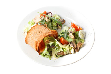 Close-up homemade fresh vegan vegetable salad with mushroom, quail egg, arugula, tomato, cucumber and cracker. Round plate. Isolated on white