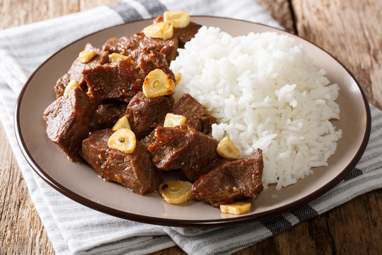 Philippine food: Salpicao beef with garlic and rice closeup on a plate. horizontal