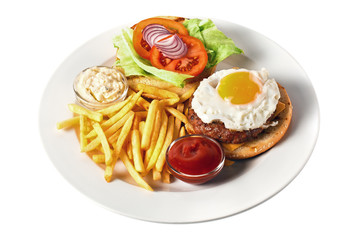 Delicious burger with grilled chicken cutlet, cheese, scrambled eggs, tomato, onion, two kind of sauces and salad, as well as potatoes and beer. On a round plate. Isolated on white