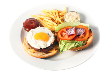 Opened cheese burger with grilled cutlet, cheese, scrambled egg with yolk, tomato, onion, two kind of sauces and salad, as well as roasted potatoes On a round plate. Isolated on white