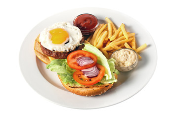 Breakfast. Burger with grilled beef cutlet, cheese, scrambled eggs with yolk, tomato, onion, two kind of sauces and salad. Roasted potato. On a round plate. Isolated on white