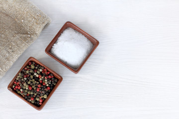 two important spices for the kitchen/ large salt and sweet pepper in colored peas on a light table top view © zoomingfoto1712