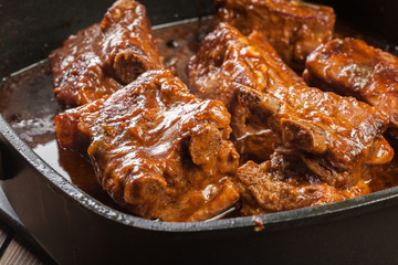 Pork spare ribs on dish in own sauce