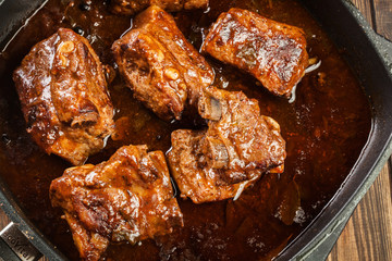 Pork spare ribs on dish in own sauce