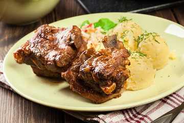 Pork spare ribs served with mashed potatoes and sauce