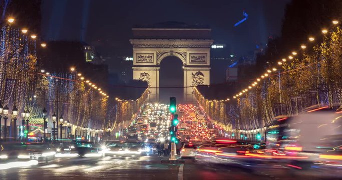 Christmas in Paris. Timelapse of avenue des Champs-Elysees with Christmas lighting leading up to the Arc de Triomphe in Paris, France. Crash zoom effect.