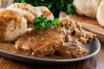 Pork loin in gravy with bread dumplings and sauerkraut