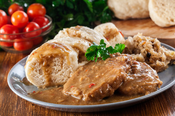 Pork loin in gravy with bread dumplings and sauerkraut