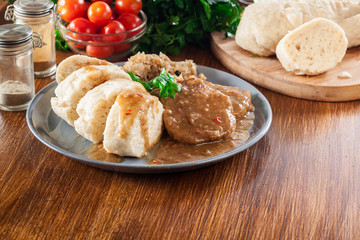 Pork loin in gravy with bread dumplings and sauerkraut