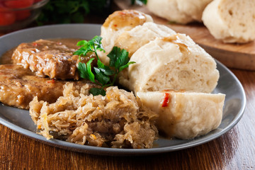 Pork loin in gravy with bread dumplings and sauerkraut