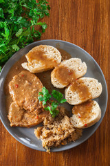 Pork loin in gravy with bread dumplings and sauerkraut