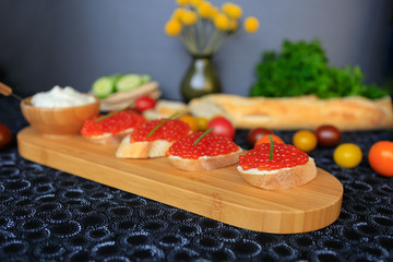 Close up of four sandwiches with red caviar