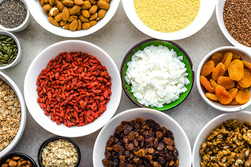 Table with food, selection of superfoods, fruits, berries, nuts, seeds, ingredients of healthy breakfast