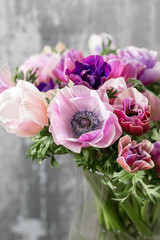 bouquet of mixed anemones flowers in vase . the work of the florist at a flower shop.
