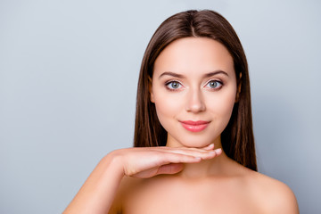 Fototapeta premium Close up portrait of young woman showing her perfect natural clean fresh face skin. Cosmetology, beauty and spa concept