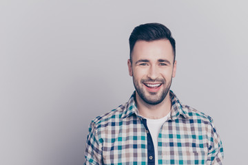 Portrait with copy space of cheerful, attractive, happy man looking at camera standing over grey background