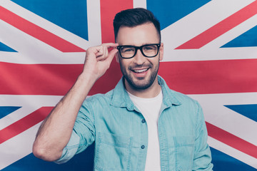 English language learning concept-portrait of cheerful man with bristle holding his hand on glasses...