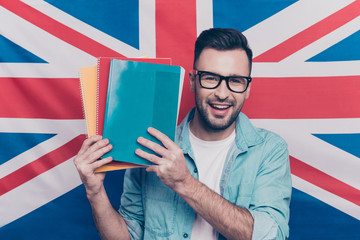 English language learning concept-portrait of cheerful attractive man with bristle showing colorful...