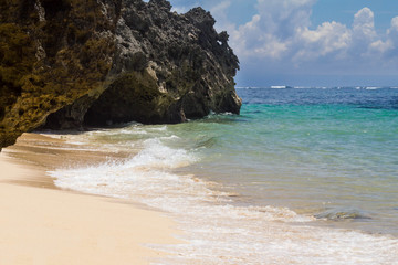 Ocean view and white foam of waves in the wild beach of Bali, Indonesia