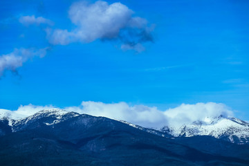 Naklejka na ściany i meble Mountain snow peak, beautiful natural winter backdrop. Ice top of the hill, blue sky background. Alpine landscape.