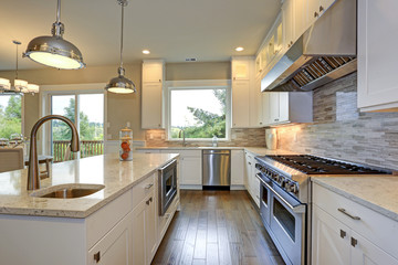 Luxury white kitchen with large kitchen island.