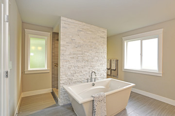 Fototapeta na wymiar Amazing master bathroom with a freestanding bathtub