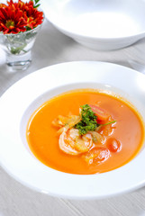close up of lobster soup on white plate