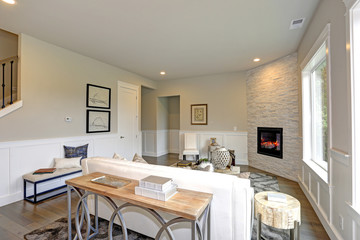 Luxury living room features corner stone fireplace