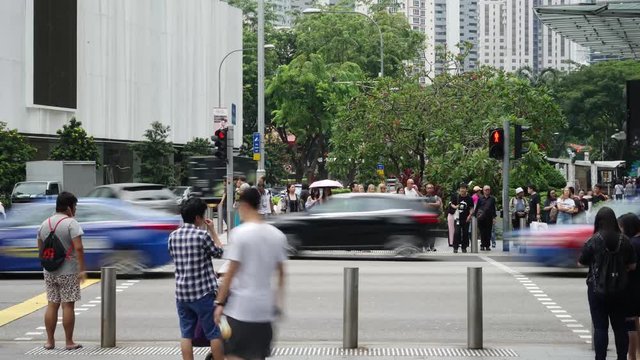 Singapore - November 27, 2017: Timelapse footage of many pedestrians cross on Orchard Road Singapore. Shot in 4k resolution