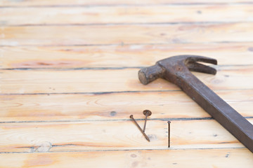 Hammer with nail on wood