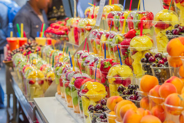 Fruit stand store at La Boqueria market, a famous old market in Barcelona. Summer food concept